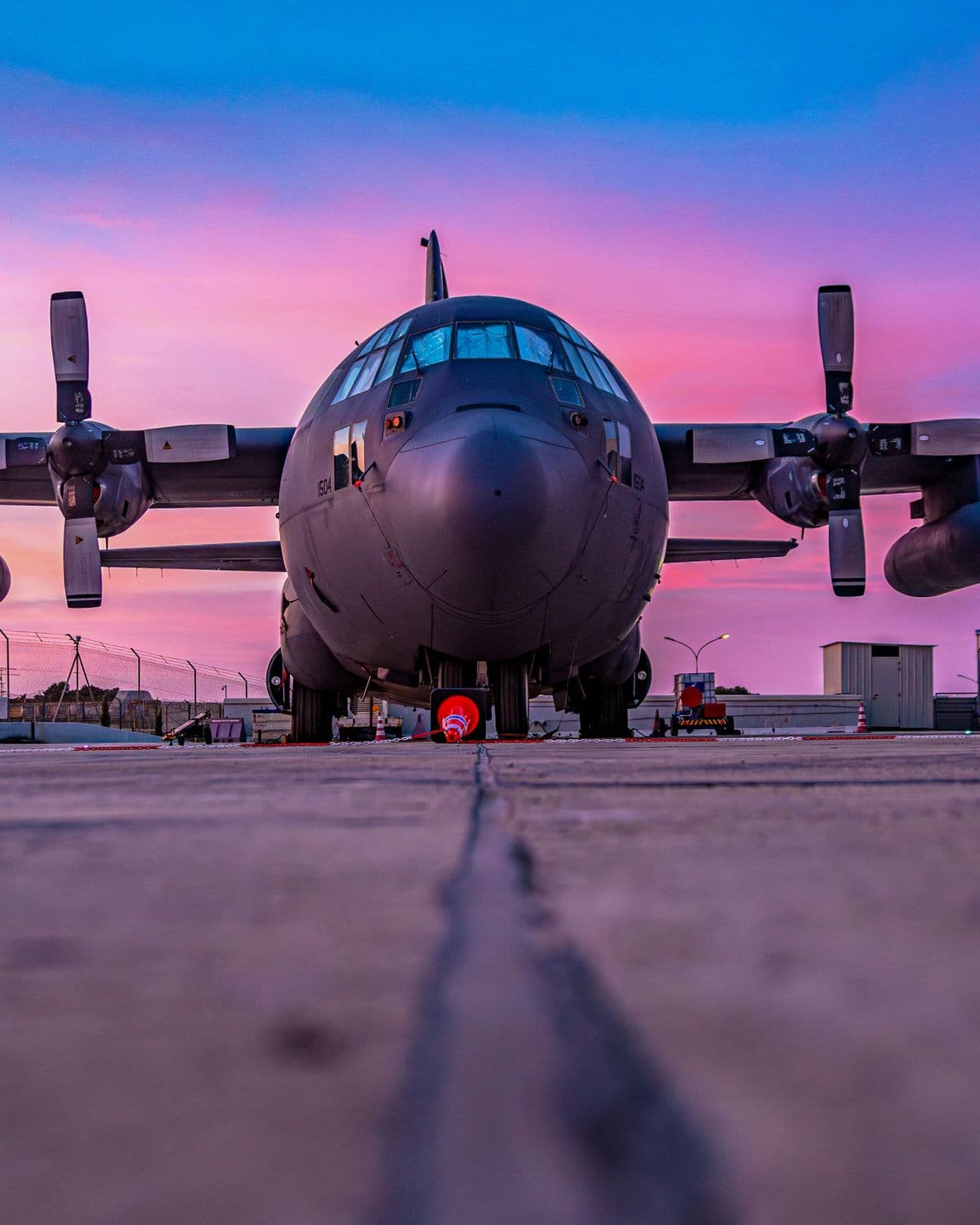 Military cargo aircraft on the flight line at dusk