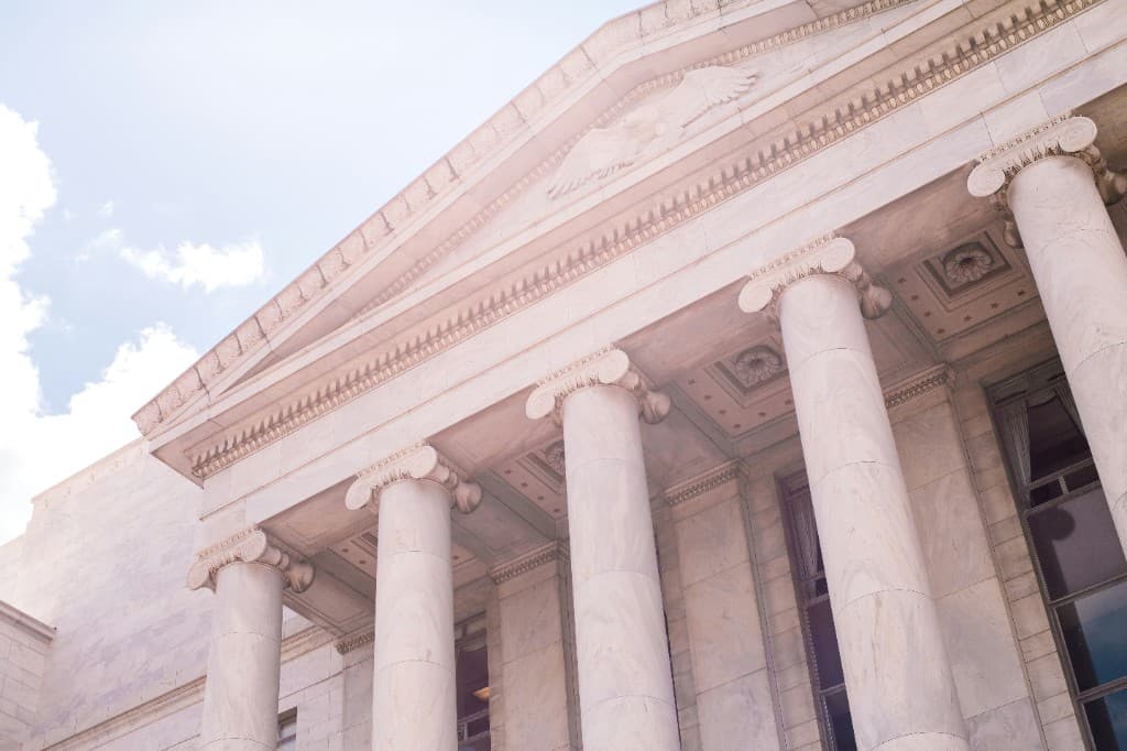 Classical government building with stone columns and a carved eagle